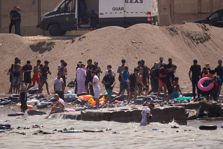Migrants cross from Morocco into the Spanish enclave of Ceuta, Thursday, July 30, 2026. (AP Photo/Antonio Sempere)