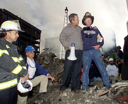 El entonces presidente George W. Bush, junto a un bombero en las ruinas del World Trade Center, en Nueva York.